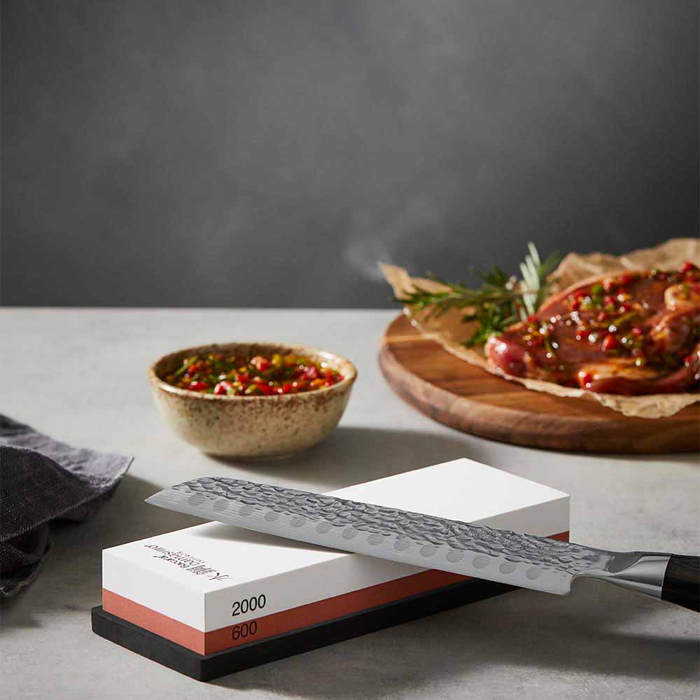 Knife sitting on top of a whetstone 600/2000 - Robins Kitchen