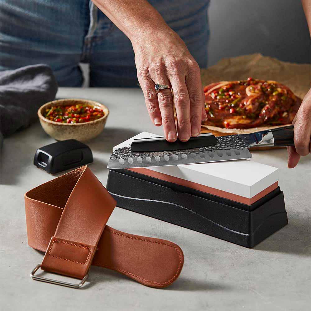 Woman sharpening knife with a whetstone - Robins Kitchen