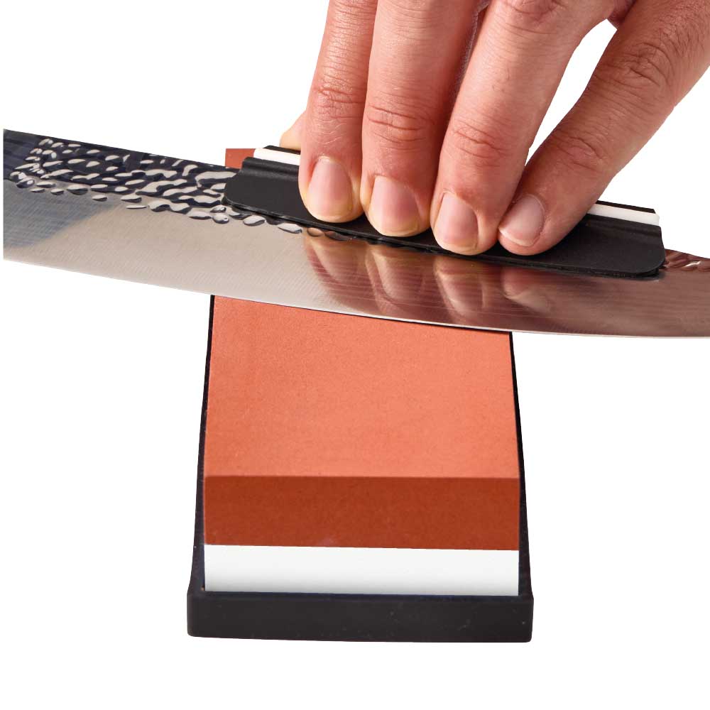 Man sharpening knife with whetstone - Robins Kitchen