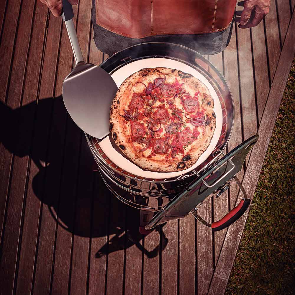 Man cooking pizza on bbq with pizza spatula - Robins Kitchen