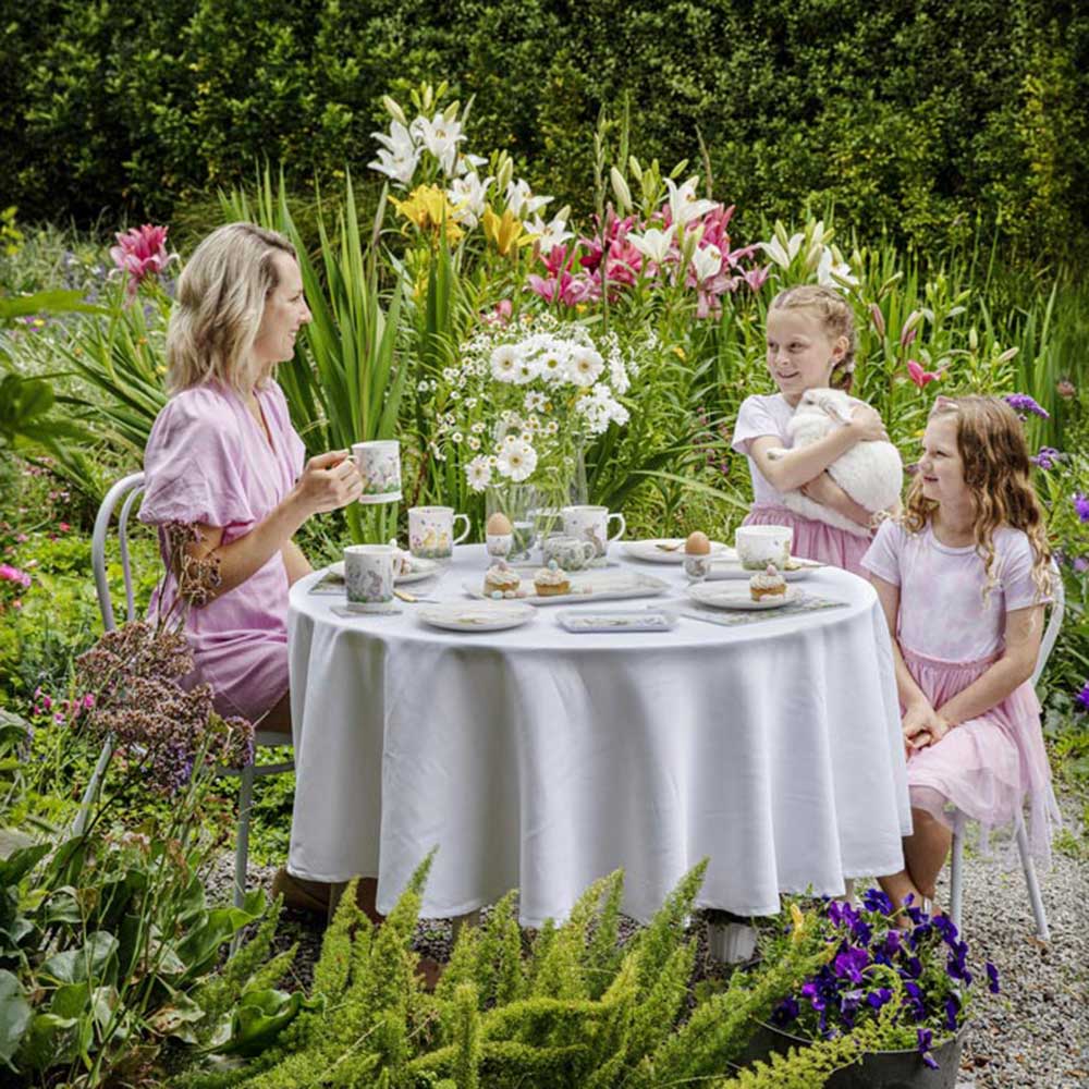 Family around the dining table outside -Ashdene Sweet Meadows Collection at Robins Kitchen