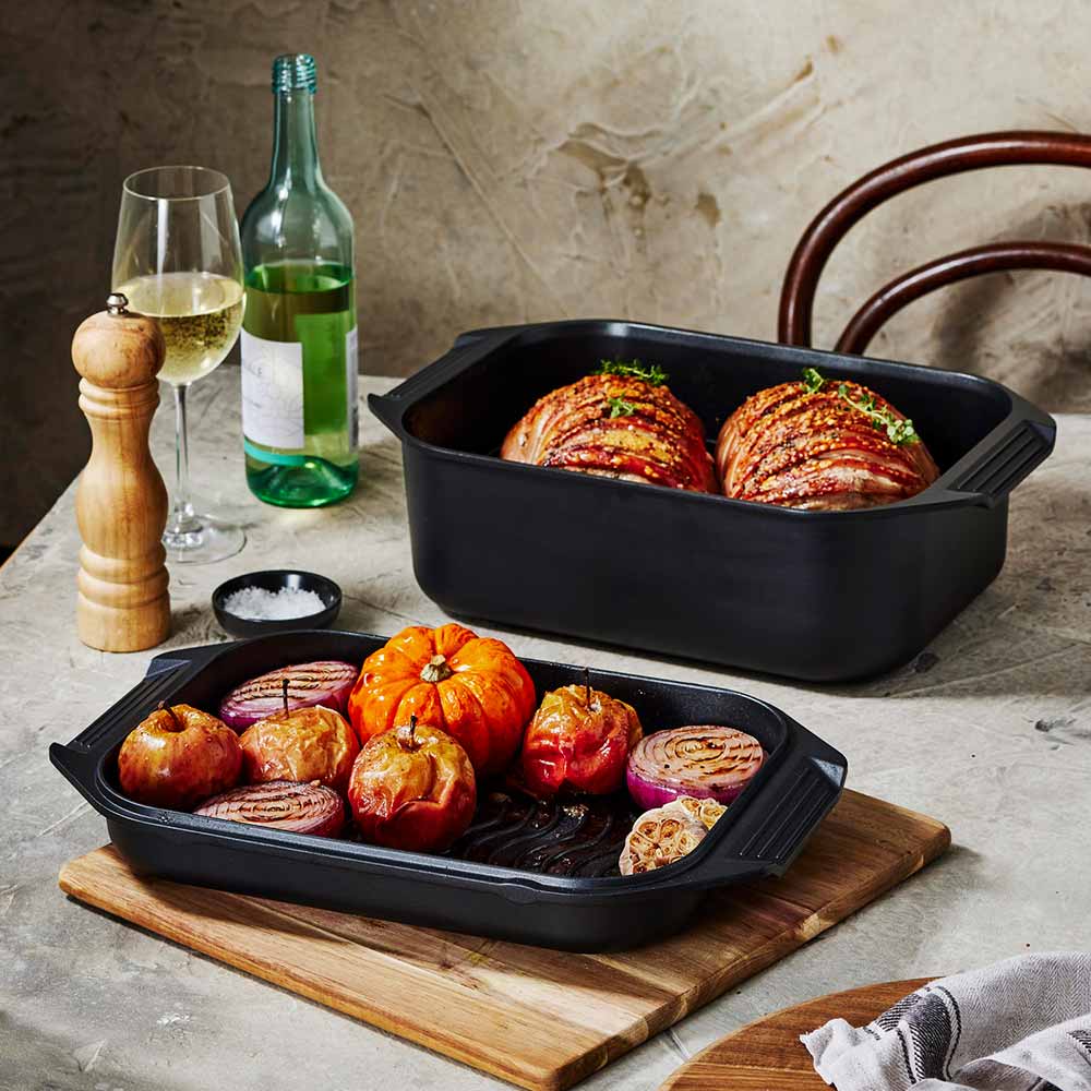 Bessemer Non Stick Roaster & Grill 34cm Black at Robins Kitchen on a wooden board with roast pork and vegetables