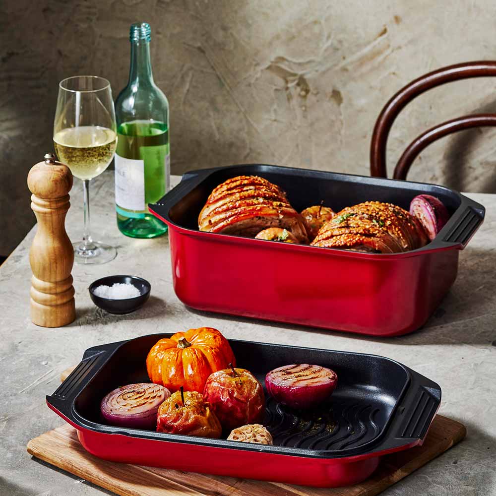Bessemer Non Stick Roaster & Grill 34cm Red at Robins Kitchen on a wooden board with roast pork and vegetables
