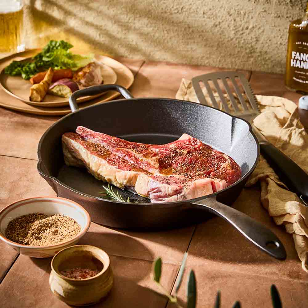 BBQ slotted turner next to cast iron pan with steak - Robins Kitchen