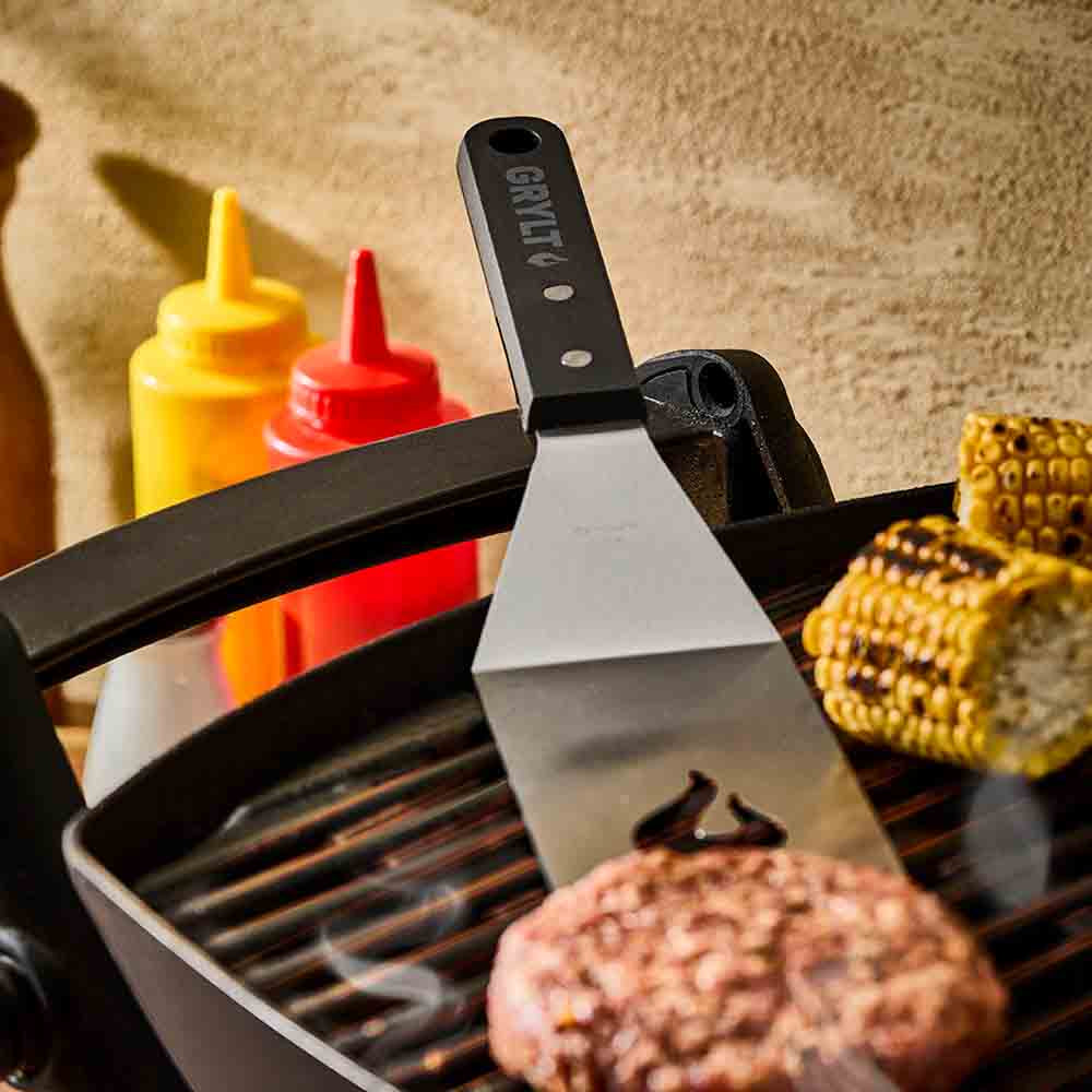 slotted griddle spatula turning a burger patty on BBQ - Robins Kitchen