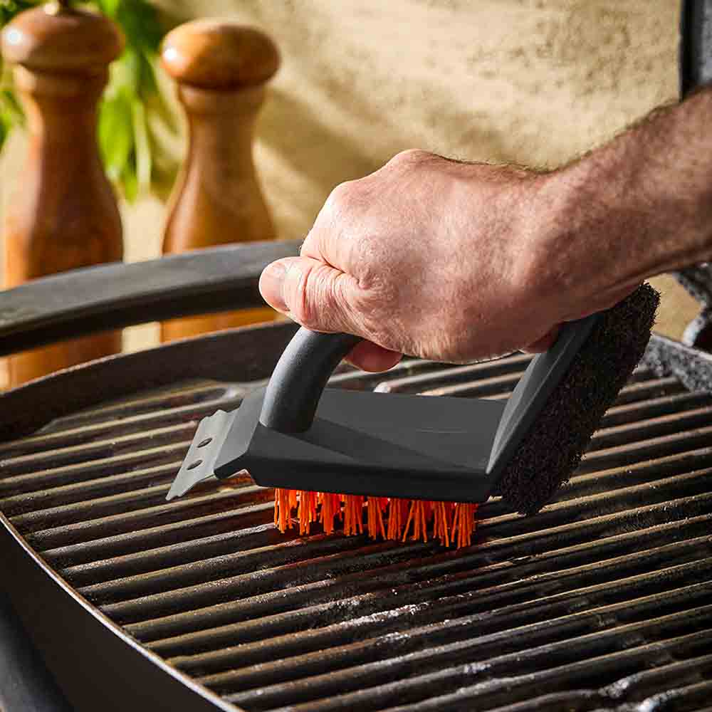 man using 3-in-1 grill brush to clean barbeque - Robins Kitchen