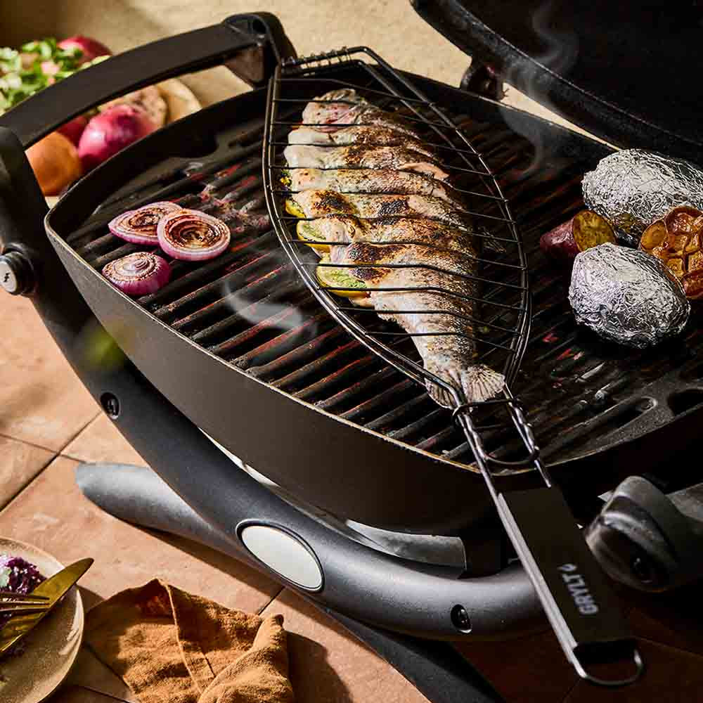 Full fish grilling in a steel fish basket on the BBQ - Robins Kitchen