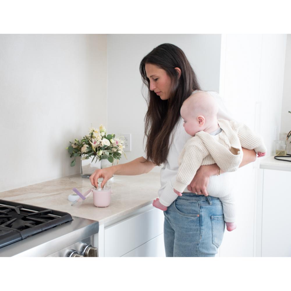 woman with baby preparing baby formula - Robins Kitchen