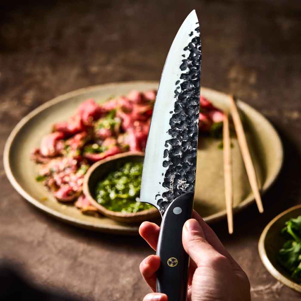 Man holding Baccarat KUROI KIBA Chefs Knife 20cm at Robins Kitchen
