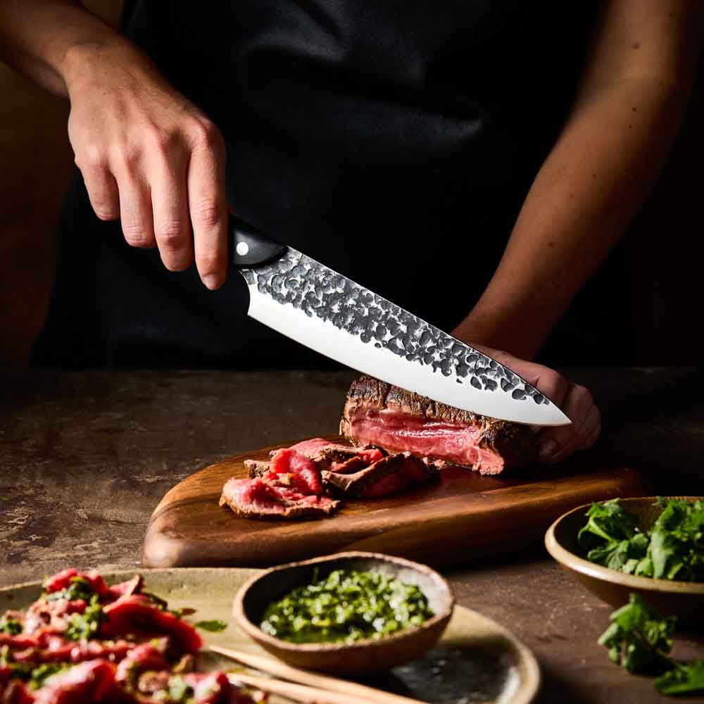 Man slicing wagyu beef with Baccarat KUROI KIBA Chefs Knife 20cm at Robins Kitchen