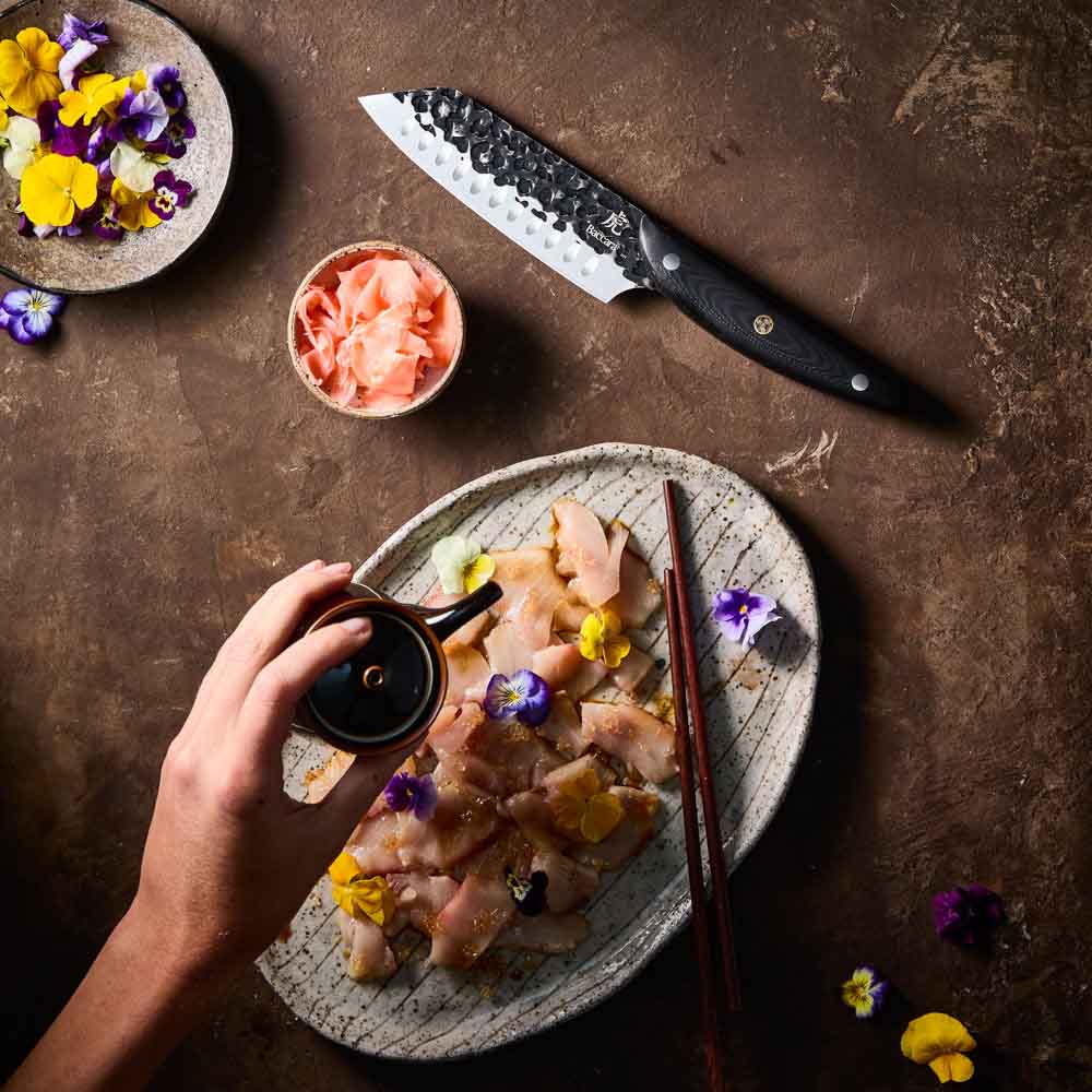 Woman pouring sauce on sashimi - Baccarat KUROI KIBA Santoku Knife 14cm at Robins Kitchen
