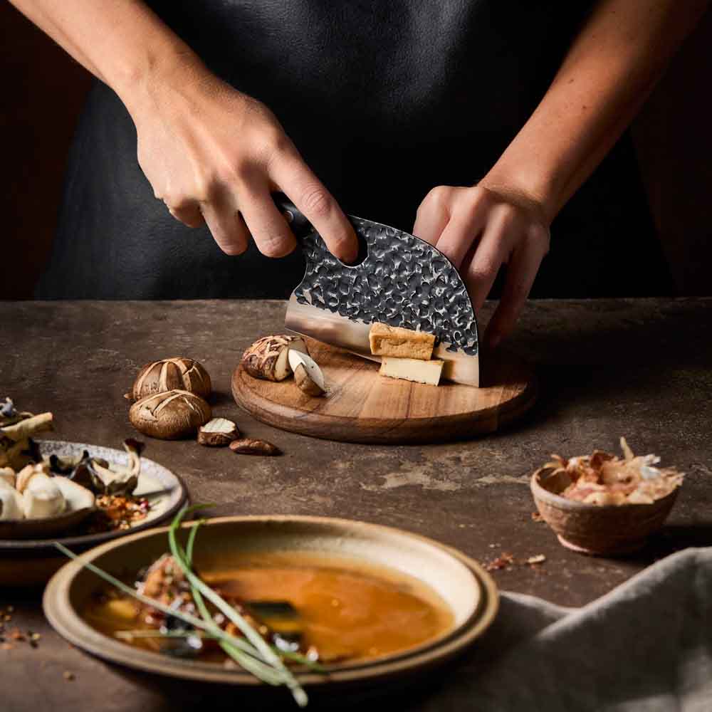 Woman slicing tofu with Baccarat KUROI KIBA Moon Knife 12.5cm at Robins Kitchen