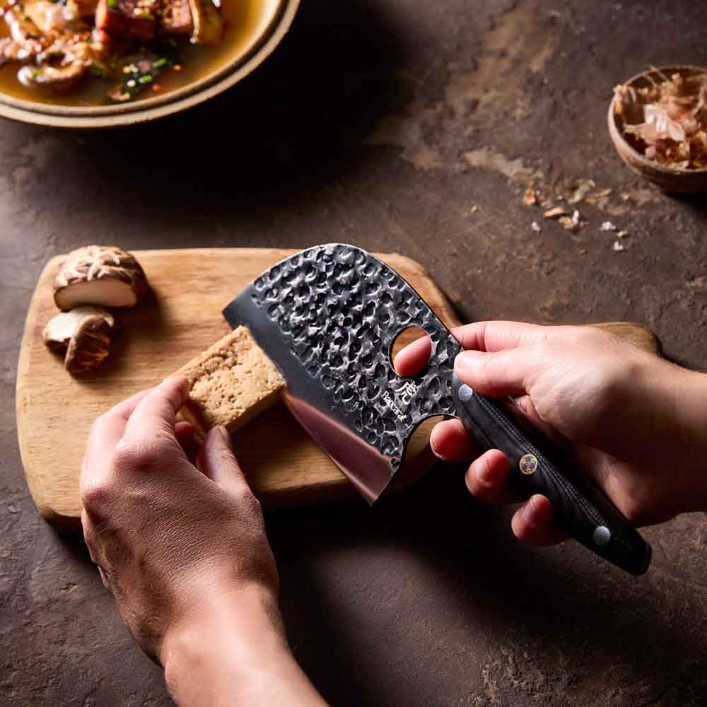 Woman slicing tofu with Baccarat KUROI KIBA Moon Knife 12.5cm at Robins Kitchen